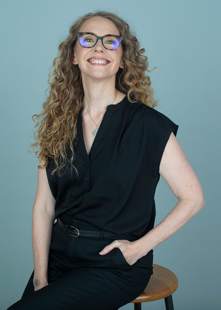 Portrait of Sara Marlowe against a blue background